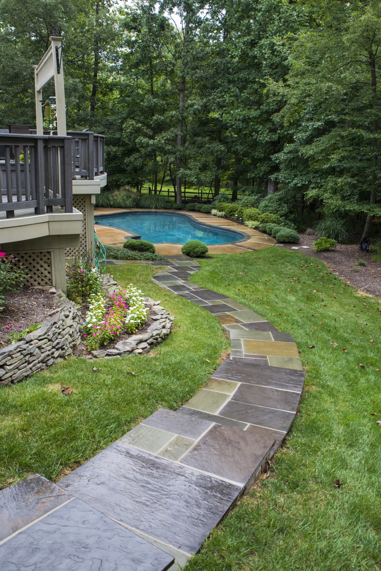Flagstone walkway curving to a backyard pool in Northern Virginia