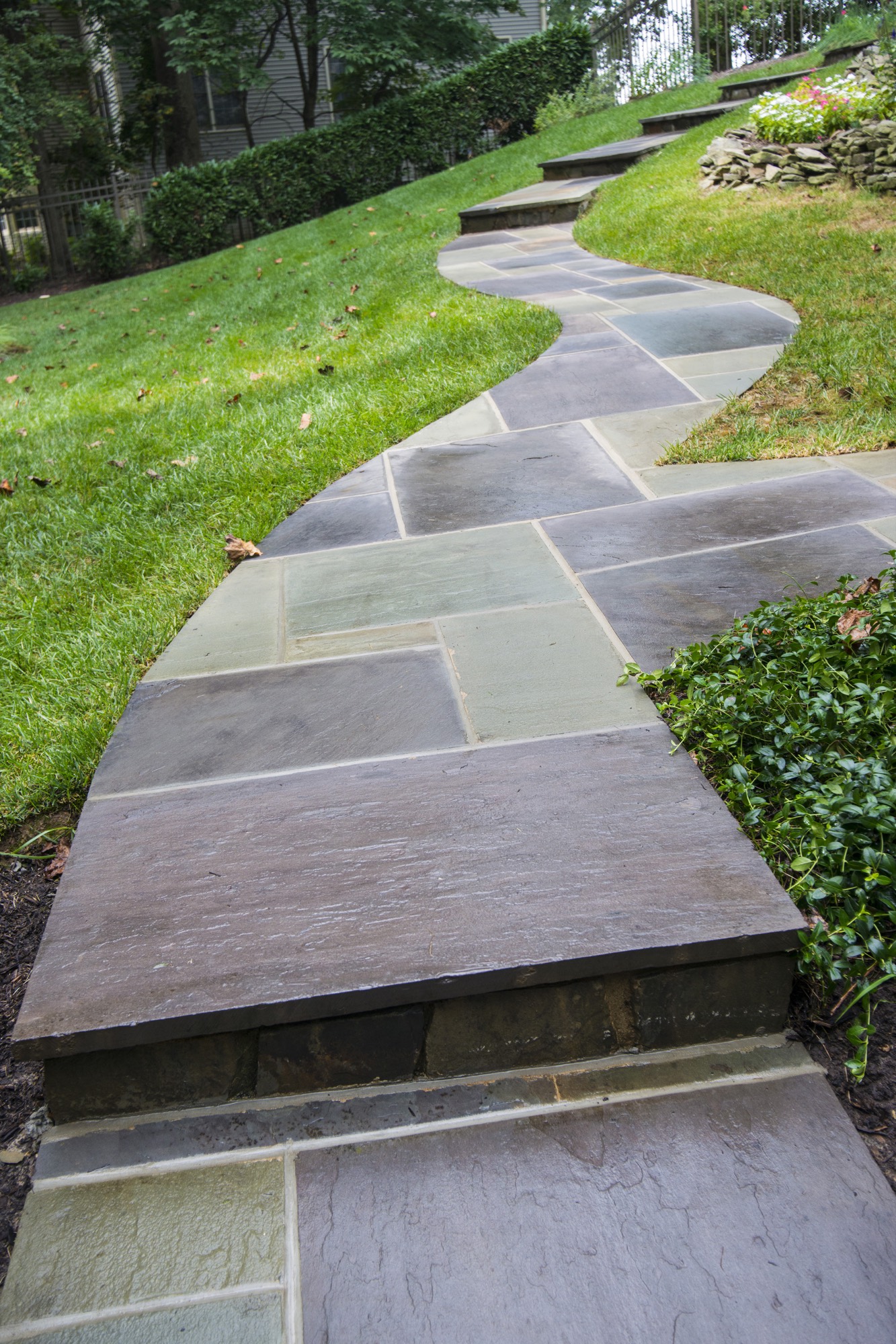 Curving flagstone walkway through a landscaped lawn in Northern Virginia