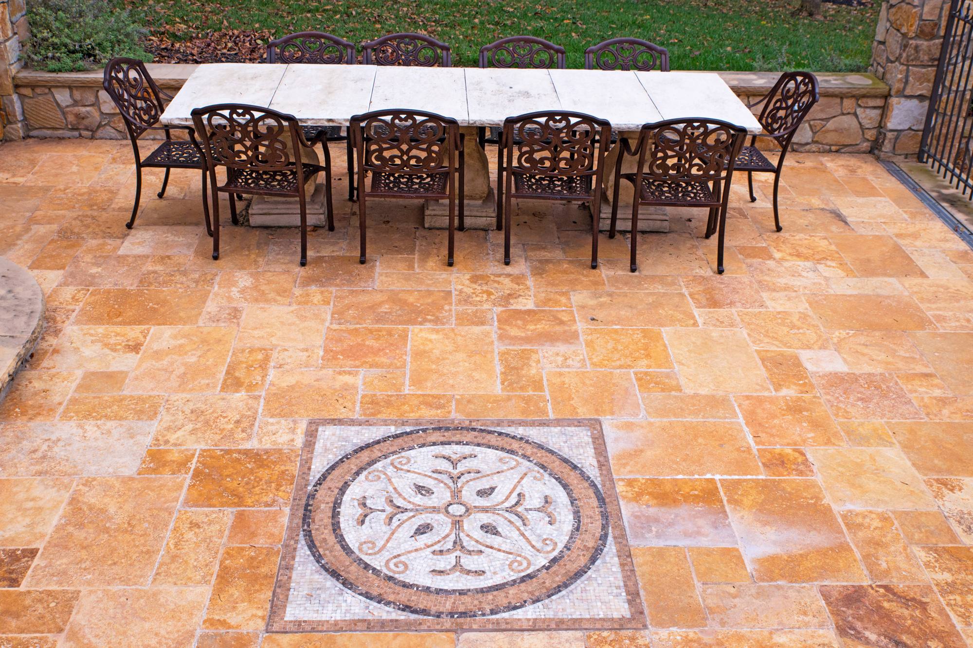 Travertine stone patio with custom medallion inlay and outdoor dining in Northern Virginia